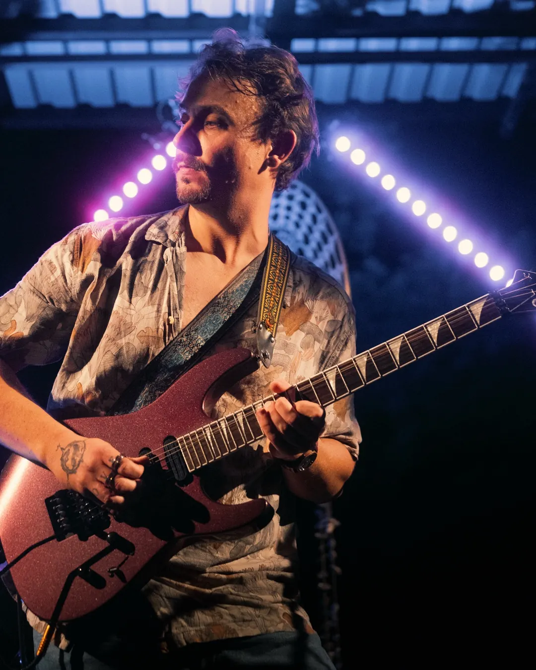 Joey Fischer bei einem Live-Auftritt mit E-Gitarre auf einer Bühne